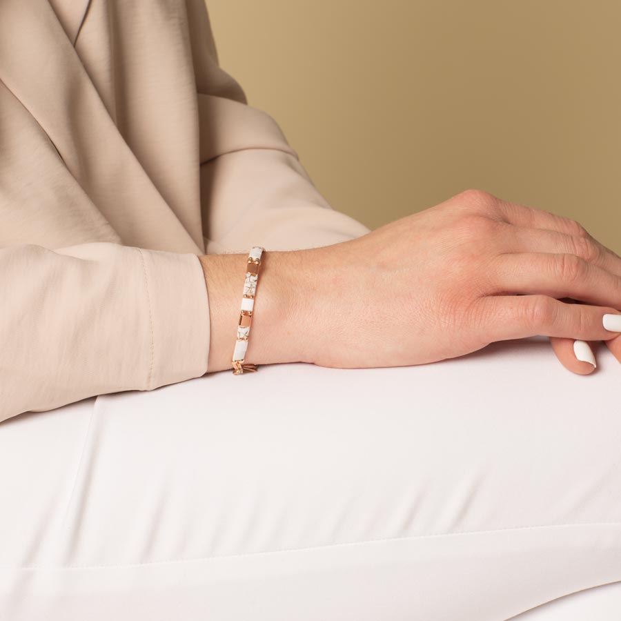 Woman wearing white and rose gold accent stretch medical ID bracelet