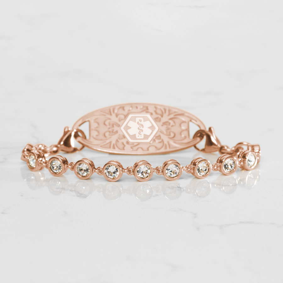 Ella Medical ID Bracelet in Rose Gold with round, bezel set, Cubic Zirconia Crystals paired with Rose Gold Gardenia Medical ID Tag on White Marble Couter