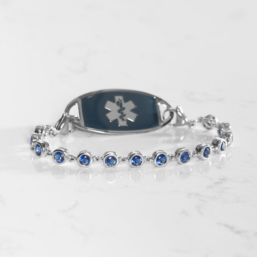 Blue bezel set crystal bracelet on marble background