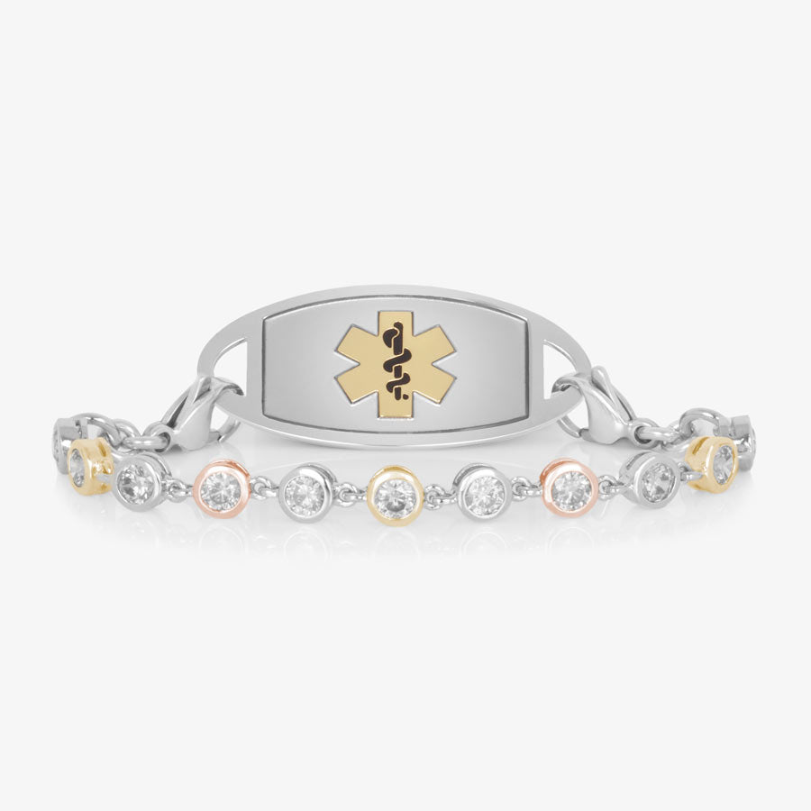 Bracelet featuring individually set, round cubic zirconia crystals, in alternating silver, rose and gold tones. Attached to a silver and gold medical ID tag.