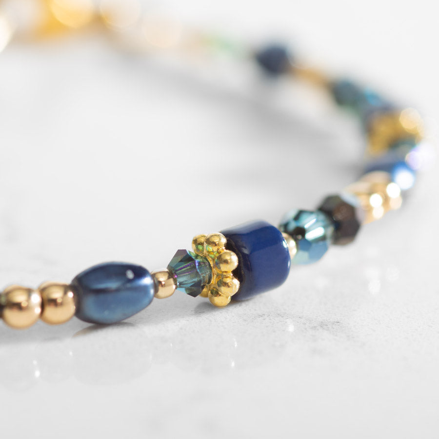 Close up of beads on blue and gold tone medical ID bracelet