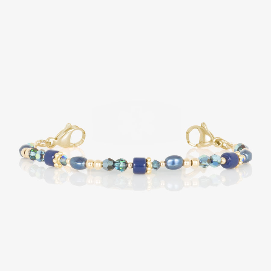 Blue and gold beaded medical ID bracelet on jewelry elastic with gold tone lobster clasps.