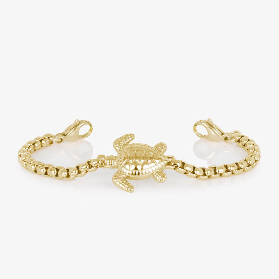 Gold tone box chain bracelet featuring a sea turtle centerpiece