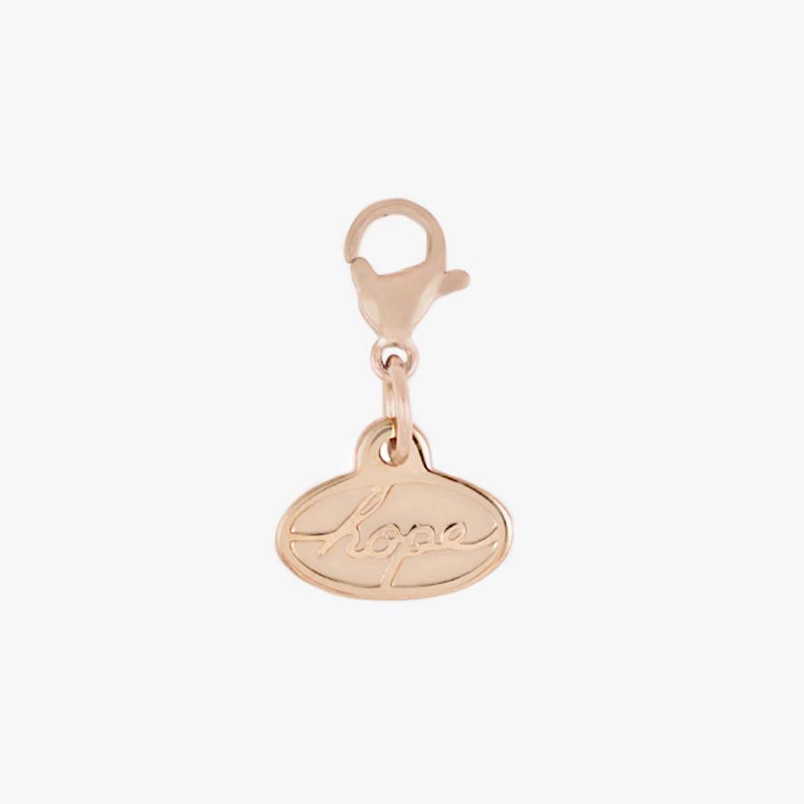 Rose gold tone oval charm with the word, "hope" in cursive letters, hanging on a matching lobster clasp