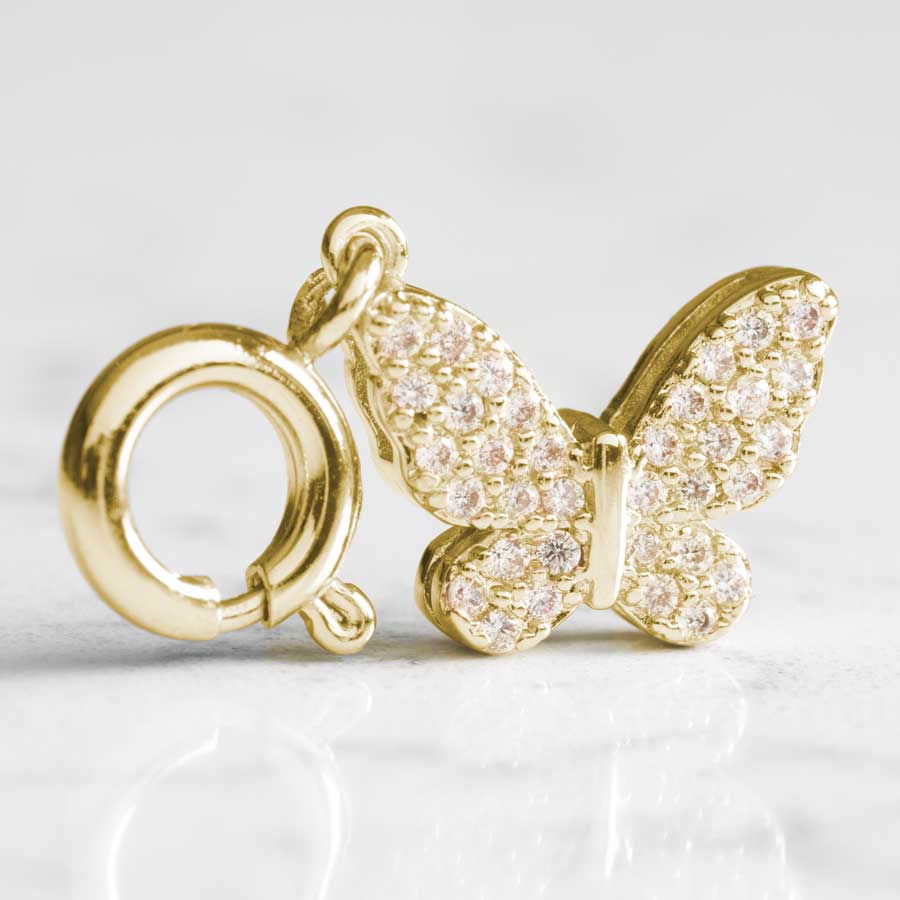 Inlaid crystals shine on both sides of the gold, butterfly charm,