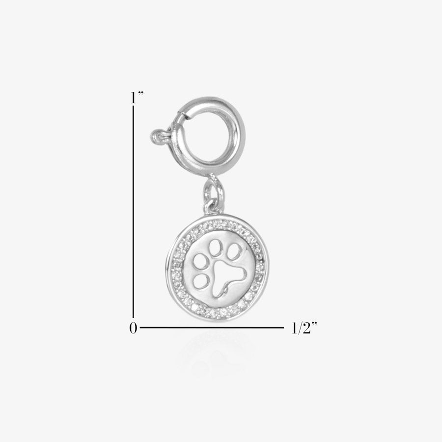 Attachable Charm featuring a cutout paw print encircled with clear, pave-set cubic zirconia crystals. Measurements showing a height of 1-inch and width of 1/2-inch