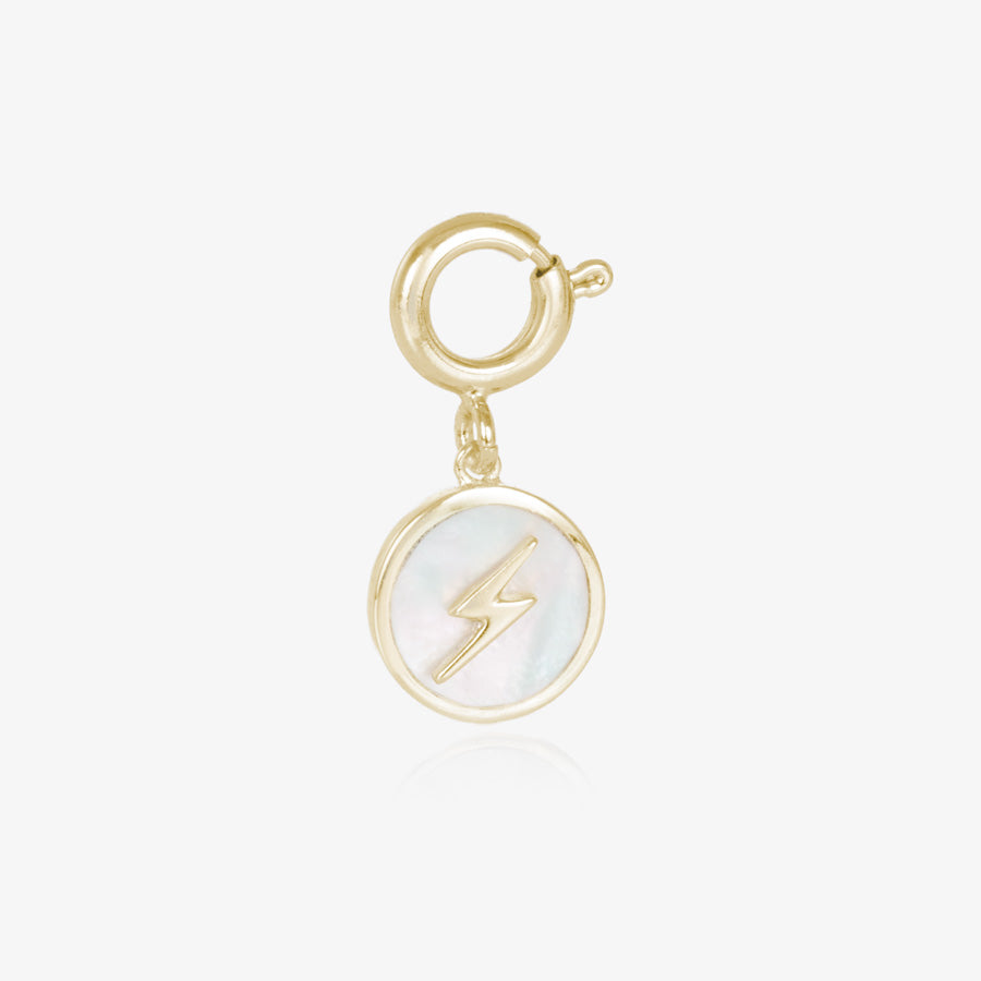 Round, gold tone charm, featuring a mother of pearl inlay with gold lightning bolt.