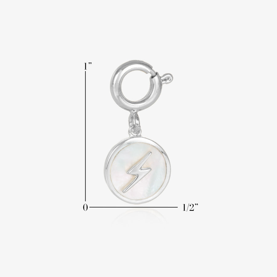 Round, silver charm, featuring a mother of pearl inlay with gold lightning bolt. Showing measurements of one inch by one half inch. 