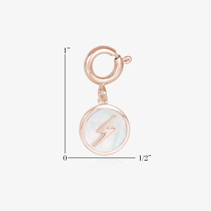 Round, rose gold tone charm, featuring a mother of pearl inlay with rose gold lightning bolt. Show measurements of one inch by one half inch. 