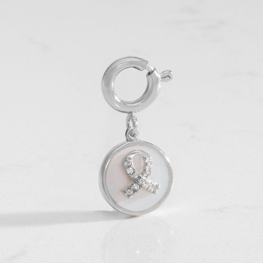 Silver tone round charm with mother of pearl inlay and silver awareness ribbon with inset crystals