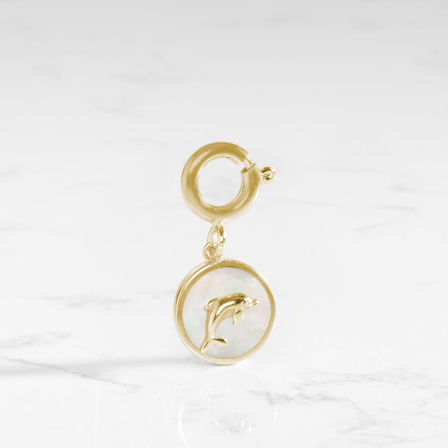 The mother of pearl inlay shines on this dolphin charm.