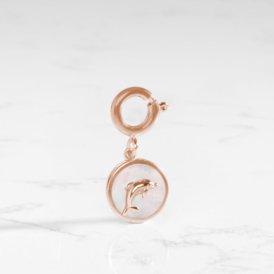 The mother of pearl inlay shines on this dolphin charm.