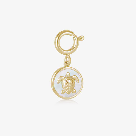 Gold toned, circle shaped charm featuring a sea turtle inset on a field of mother of pearl inly.