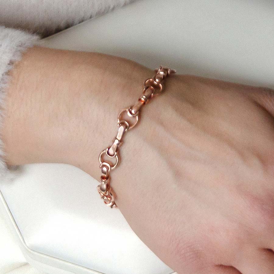 Woman wearing rose gold bridle chain medical ID bracelet