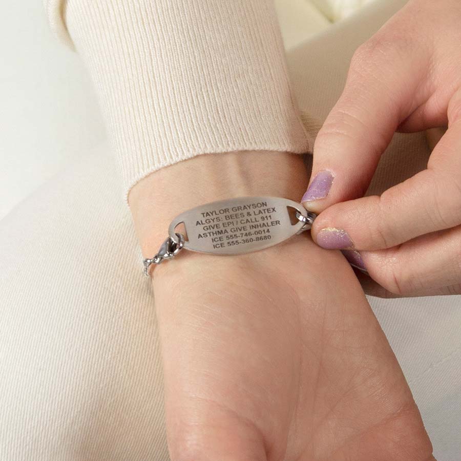 Woman showing custom laser engraved medical ID tag