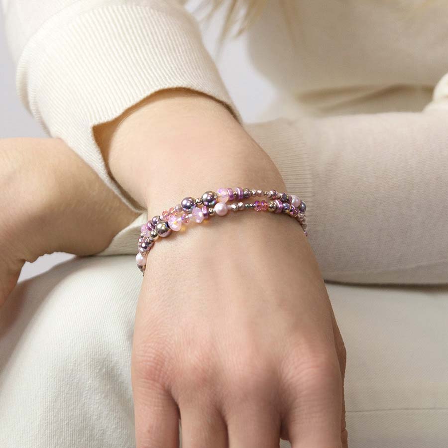 Woman wearing lavender and pink beaded medical ID bracelet with pearl accents