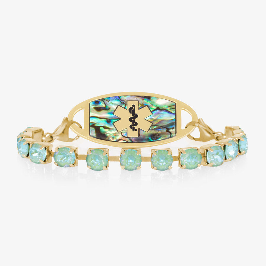 12 karat gold plated bracelet with sea green crystals paired with gold tone and abalone medical ID tag