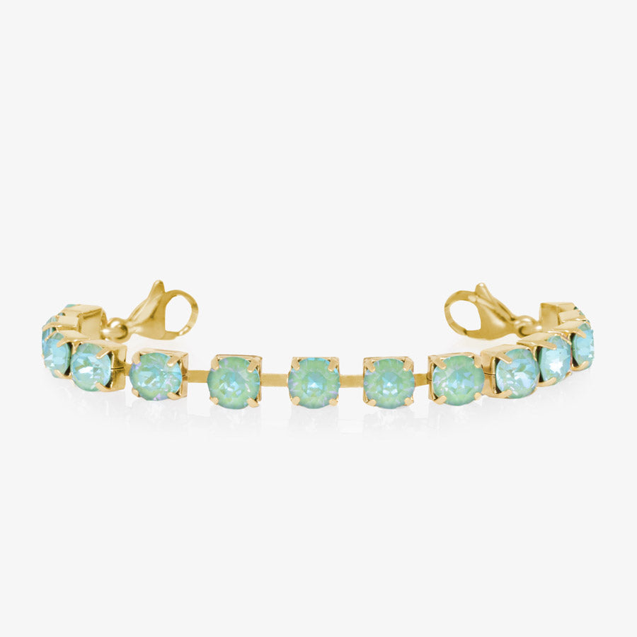 12 karat gold plated bracelet with sea green crystals with gold tone lobster clasps at each end of the bracelet.