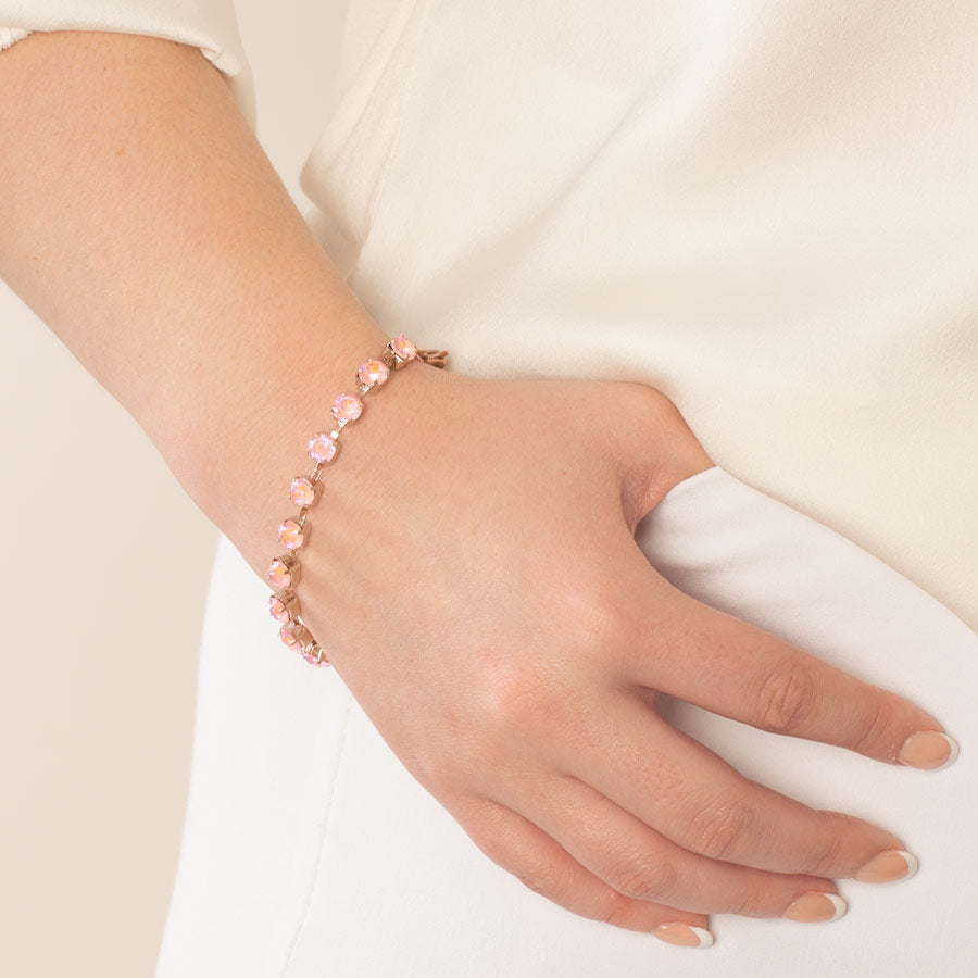 Woman showing dusty pink and rose gold crystal medical ID bracelet