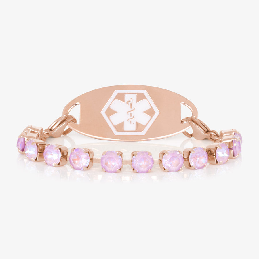 Lavender cubic zirconia crystals set in a rose gold tone chain are paired with a decorative rose gold tone medical ID tag with a white medical symbol.