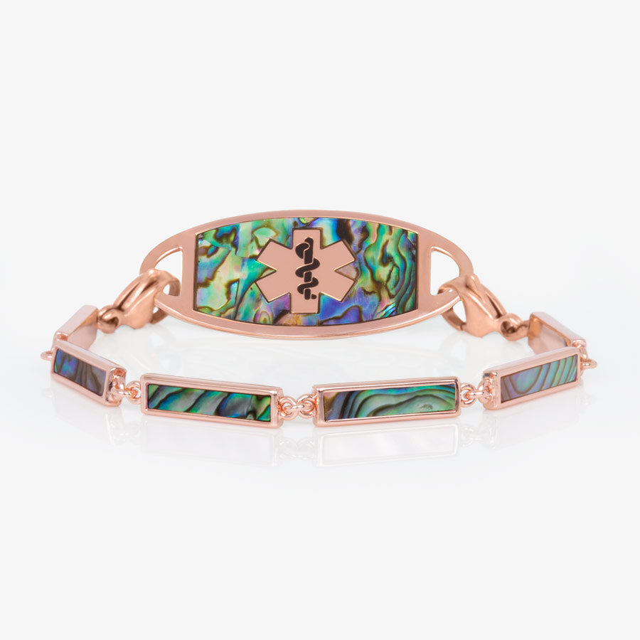 Rose gold tone bar link bracelet with natural abalone inlay shown with rose gold tone med ID tag with natural abalone inlay and rose gold medical symbol.