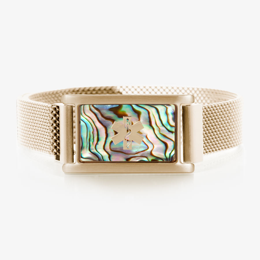 Gold tone stainless steel bracelet with adjustable mesh band and magnetic clasp with affixed ID tag with abalone inlay and gold tone medical symbol.