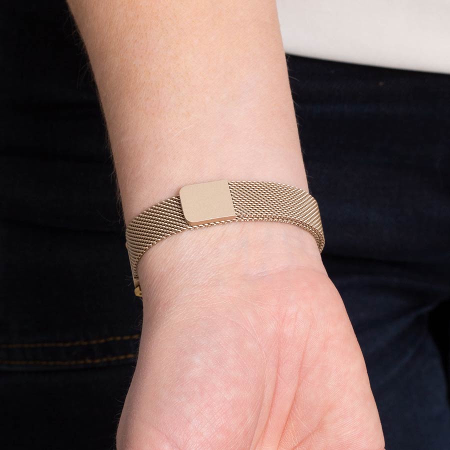 Woman wearing brushed sandstone stainless steel mesh band with magnetic clasp.