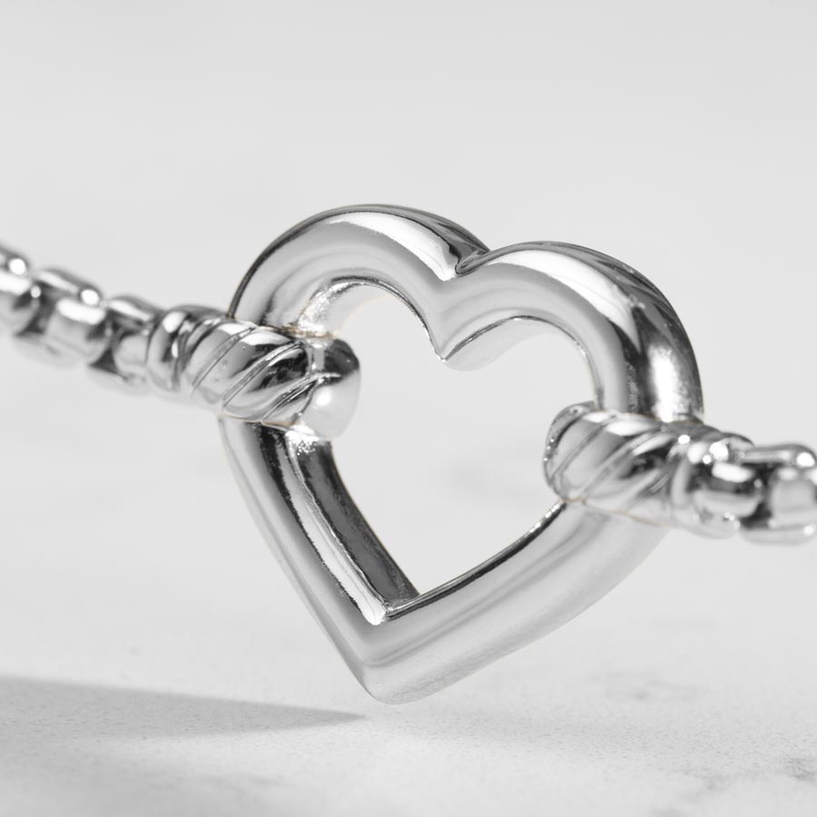 Detailed image of Silver heart shaped centerpiece.