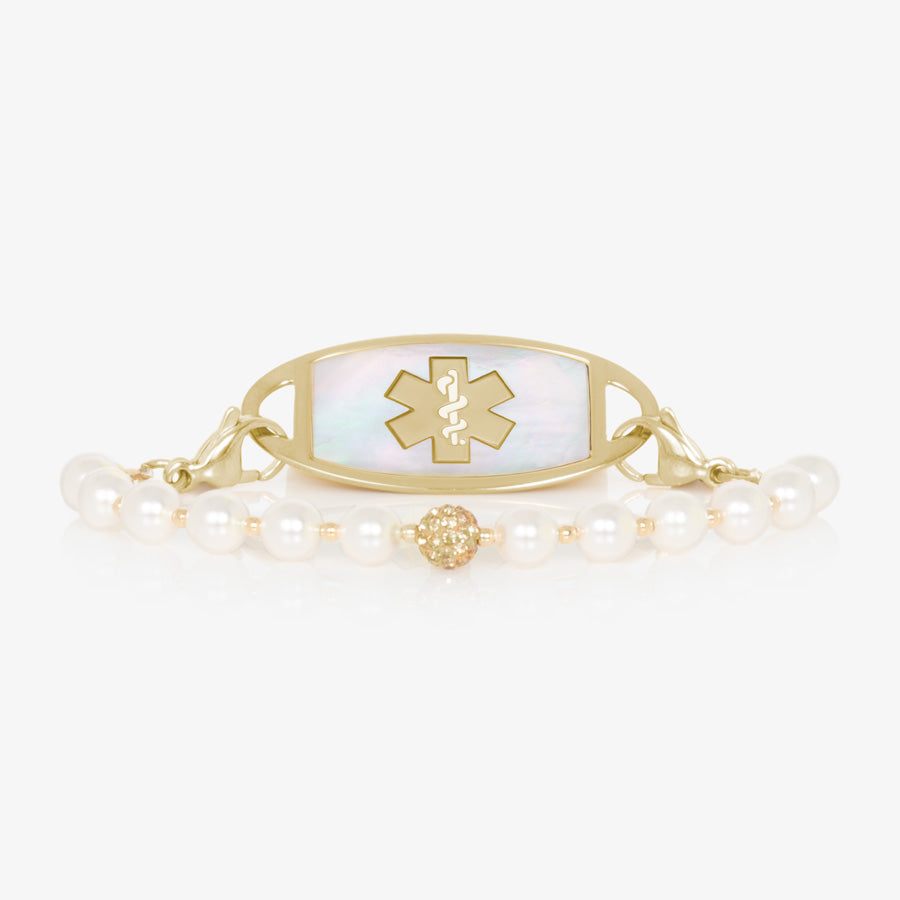 Pearl and gold tone stretch medical ID bracelet with sparkly gold tone centerpiece and gold tone stainless steel medical ID tag with mother of pearl inlay and gold tone medical caduceus.