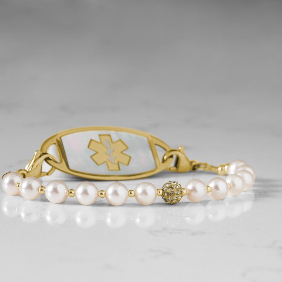 Close up image of pearls and sparkly gold tone centerpiece.