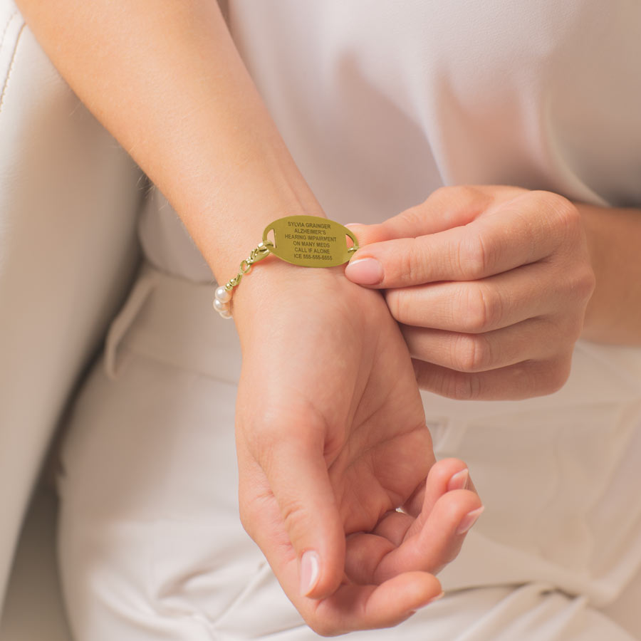 Woman showing custom laser engraved medical ID tag.