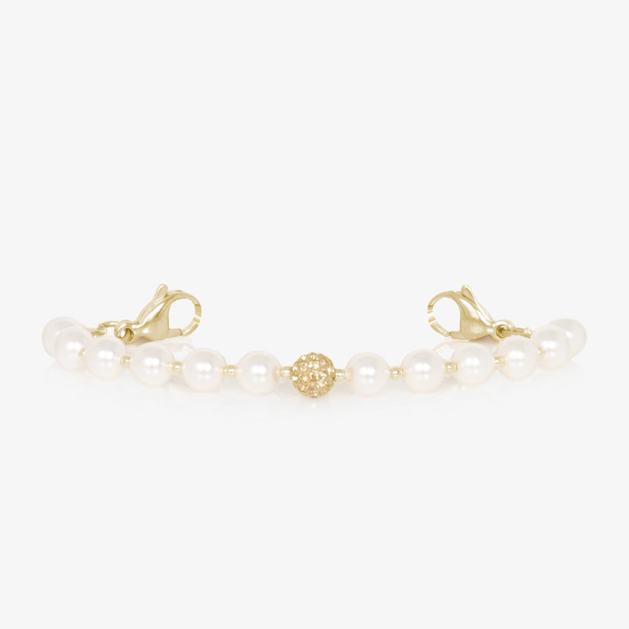 Pearl and gold tone stretch medical ID bracelet with sparkly gold tone centerpiece.