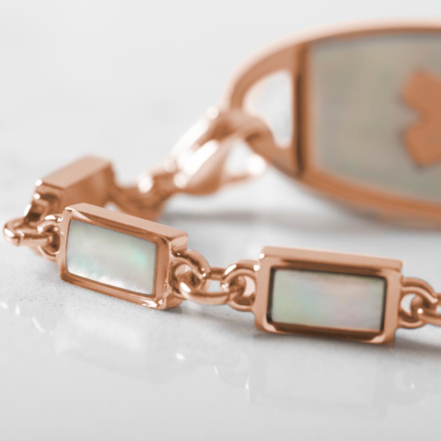 Up close image of rose gold links and mother of pearl inlay