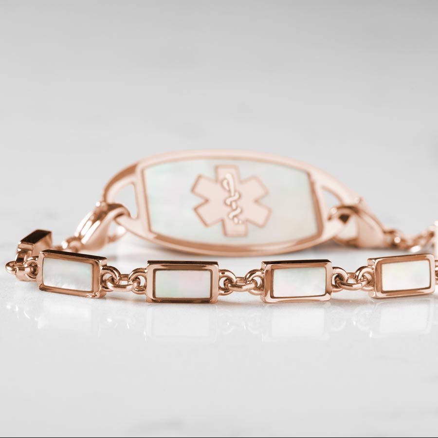 Single strand medical alert bracelet with rose gold links and mother of pearl inlay and mother of pearl medical ID tag