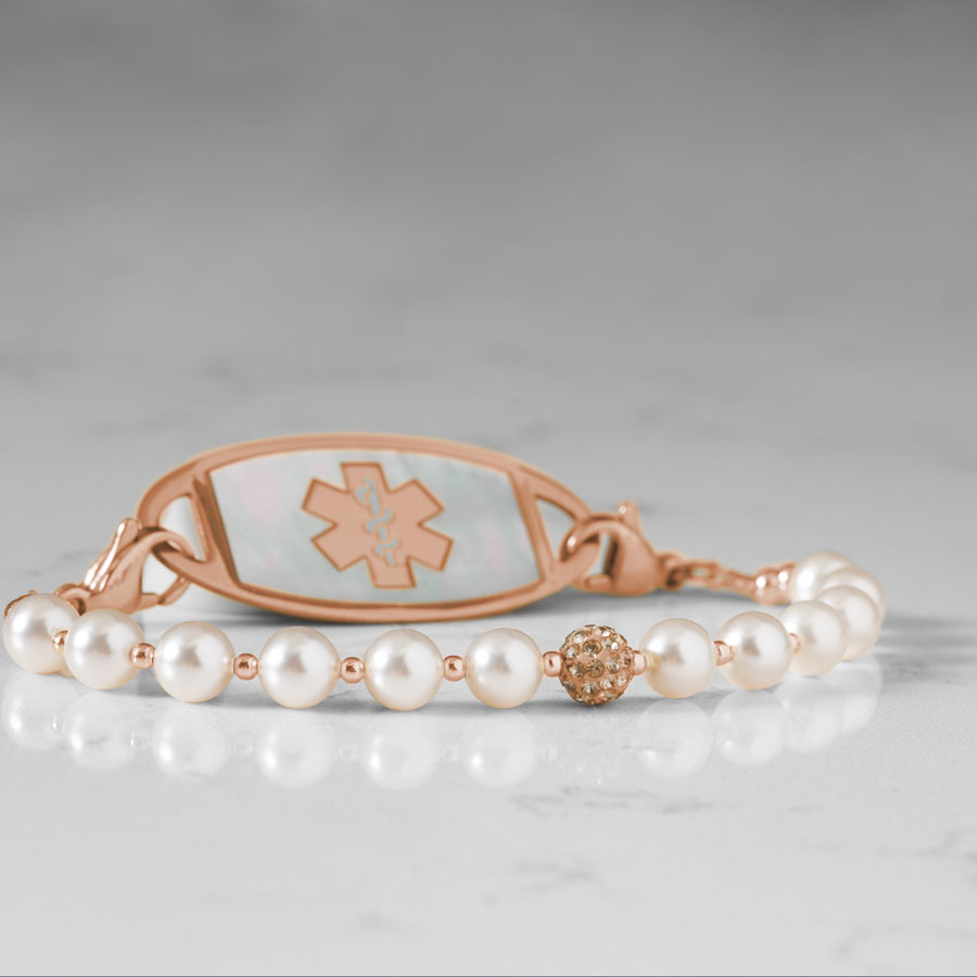 Close up image of pearls and sparkly rose gold tone centerpiece.