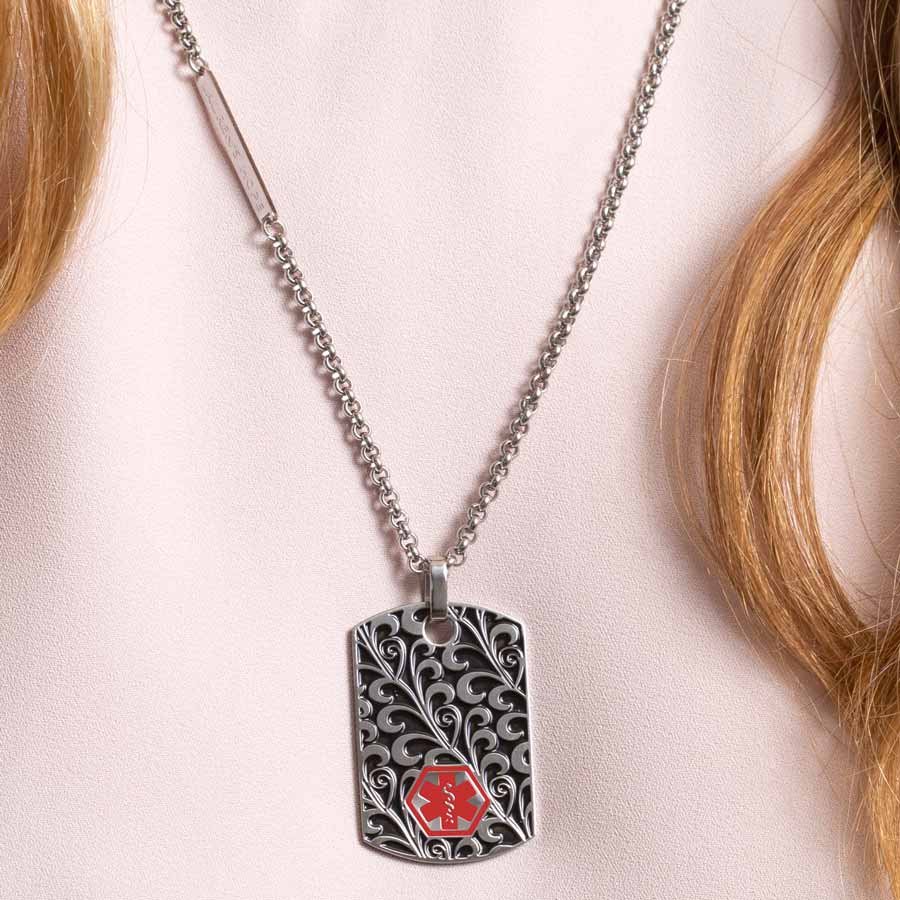 Woman wearing scrolling filigree pattern medical ID alert dog tag necklace