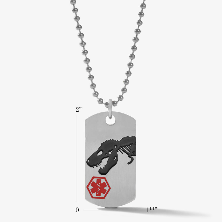 3/4" x 1-1/2" scale of the Safe T Rex Medical ID Dog Tag, a stainless tag with a roaring T-Rex, red caduceus, on a ball chain