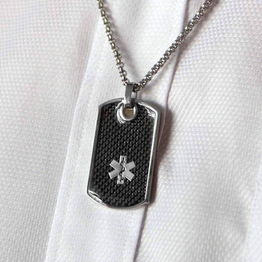 Man wearing black textured dog tag medical ID necklace.