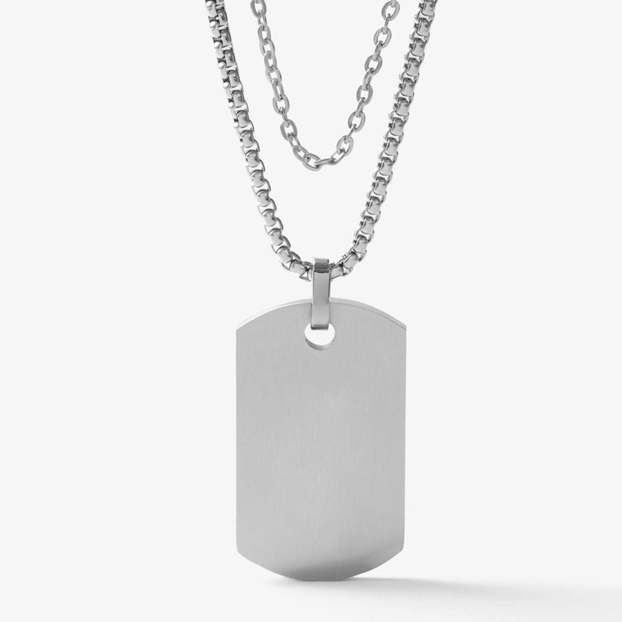 Back side of silver tone medical ID dog tag with mother of pearl inlay on silver tone snake chain layered with silver tone accent chain.