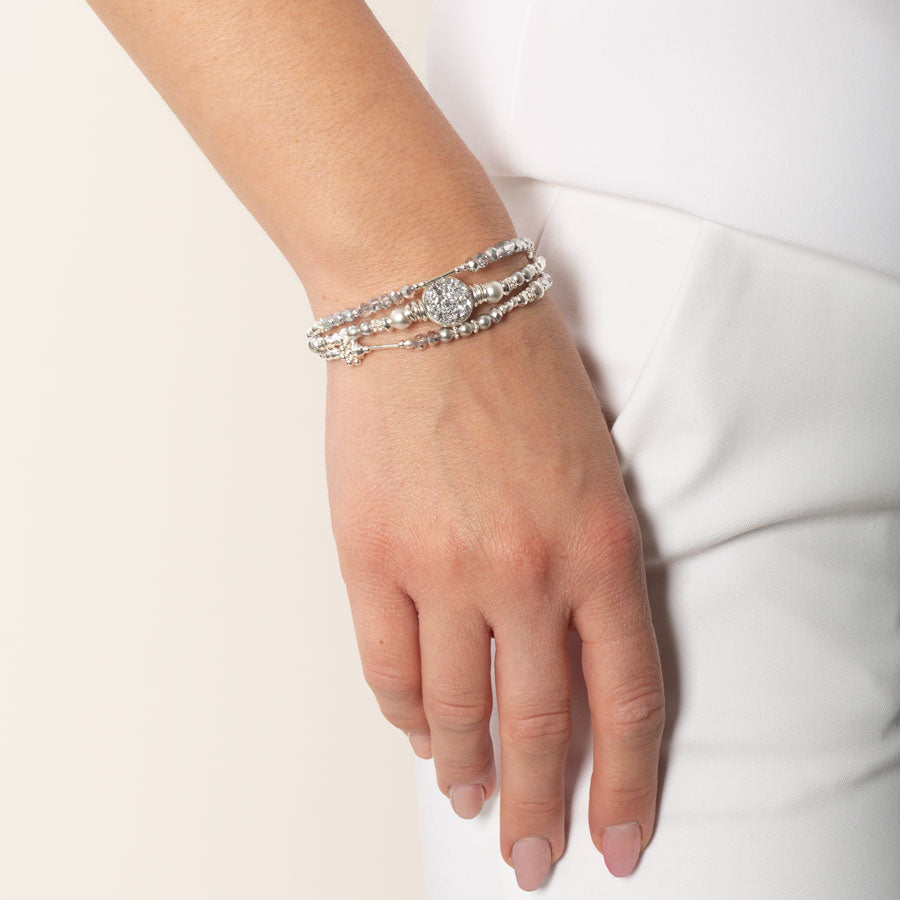 Woman wearing shimmering silver medical alert bracelets with sterling silver and crystal beads