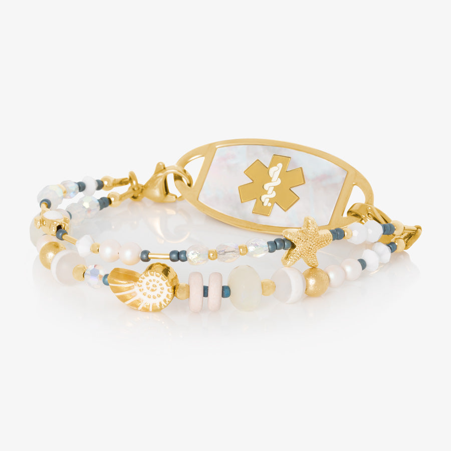 Crystal and pearl beaded medical ID bracelet with sea themed focal beads paired with gold tone medical ID tag with mother of pearl inlay.