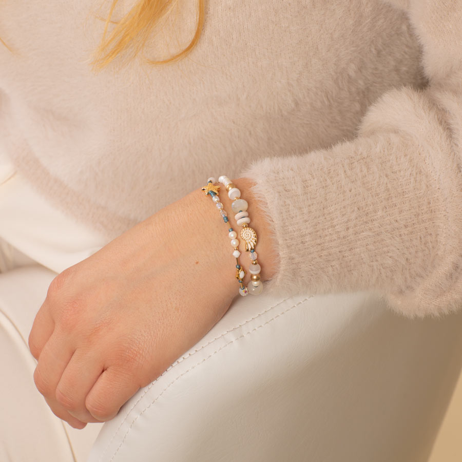 Woman wearing crystal and pearl beaded medical ID bracelet with sea themed focal beads.