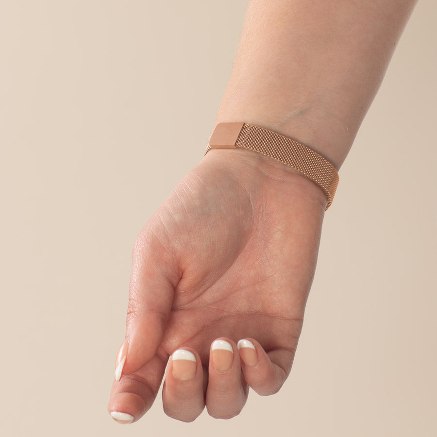 Woman showing rose gold mesh bracelet with magnetic clasp