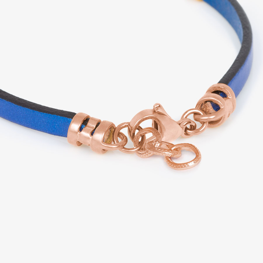 Adjustable rose gold tone chain affixed to navy blue metallic leather medical ID bracelet.