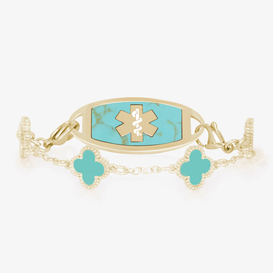 Clover shaped links with turquoise paint inlay paired with a gold medical ID tag. The tag features a gold cadu and turquoise stone inlay.