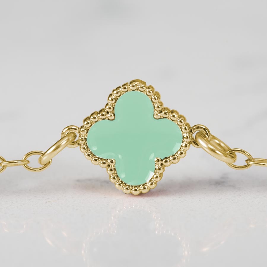 Detail image of clover shaped links with mint green enamel inlay on gold