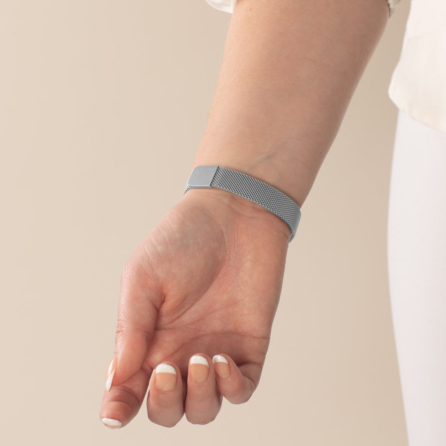 Woman wearing stainless steel mesh band with magnetic clasp.