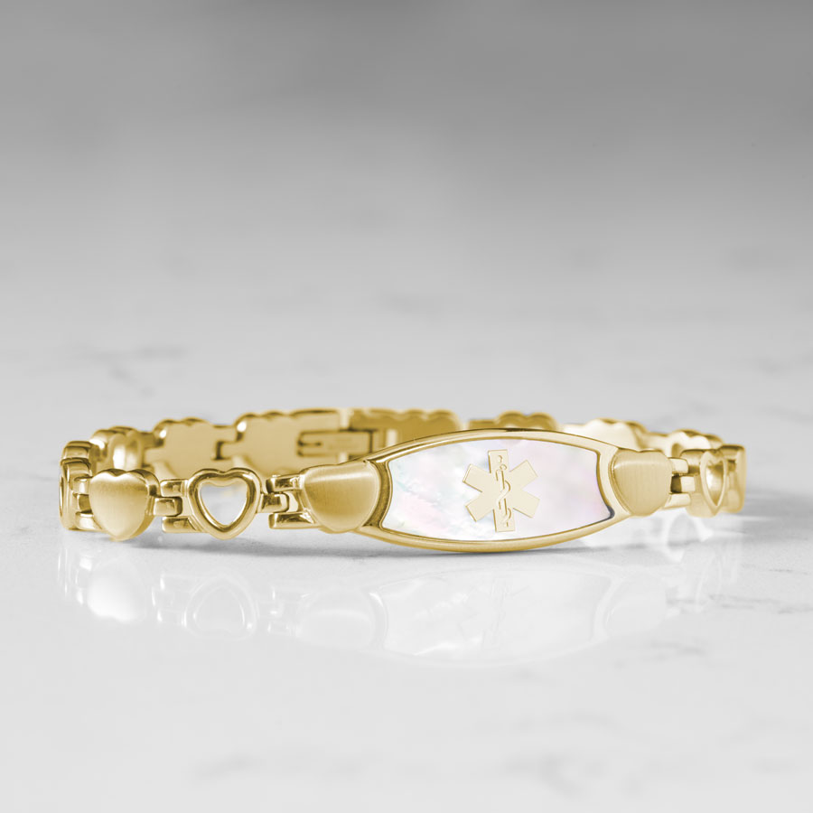 Feminine yellow gold plated linked bracelet with mother of pearl medical ID tag and yellow gold medical caduceus symbol