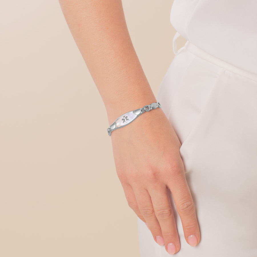 Woman wearing Mother of Pearl Love Links Medical ID Bracelet