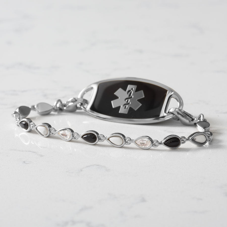 Rhodium and palladium plated medical ID bracelet with alternating teardrop links of black onyx, white howlite and clear cubic zirconia and medical ID tag with black inlay